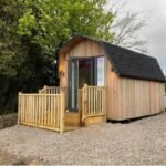 Wooden glamping pod with decking at Dragons Back